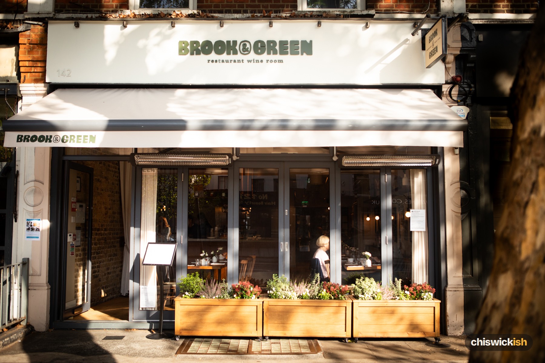 Brook & Green on Chiswick High Road, under the plane tree